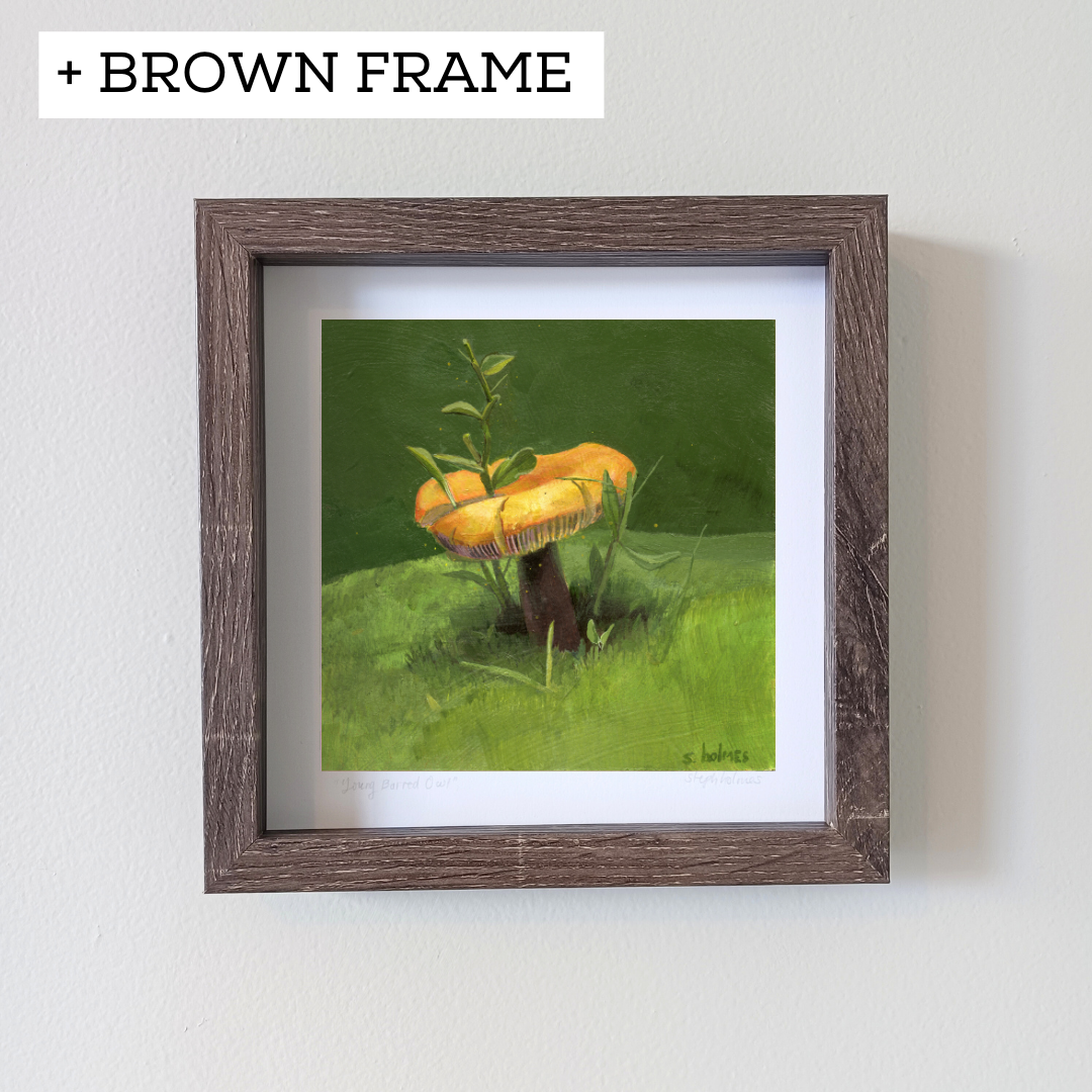 An art print featuring a golden wax cap mushroom in a brown frame on a white wall.