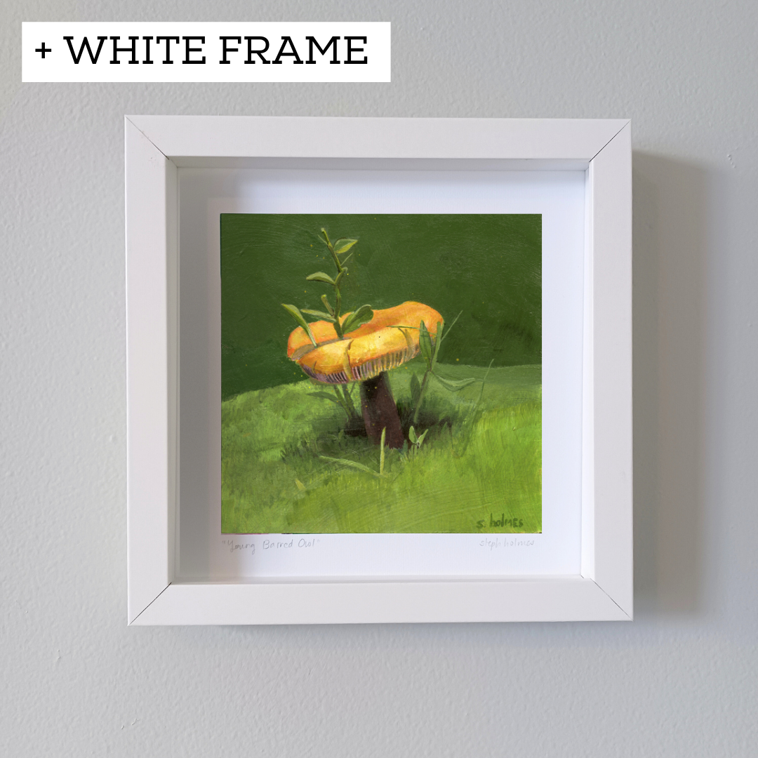 An art print featuring a golden wax cap mushroom in a white frame on a white wall.