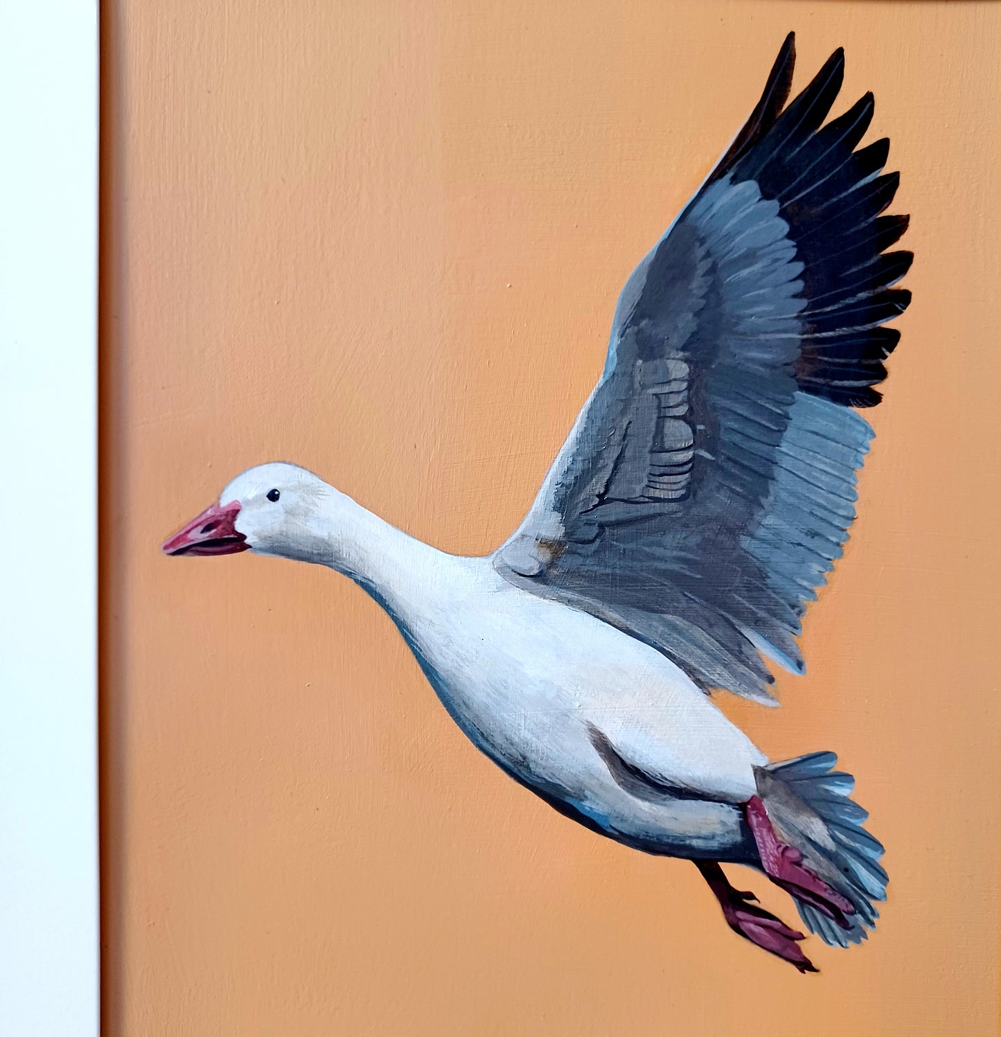 An up-close detail photo of a painting of a snow goose painting on a tan background.