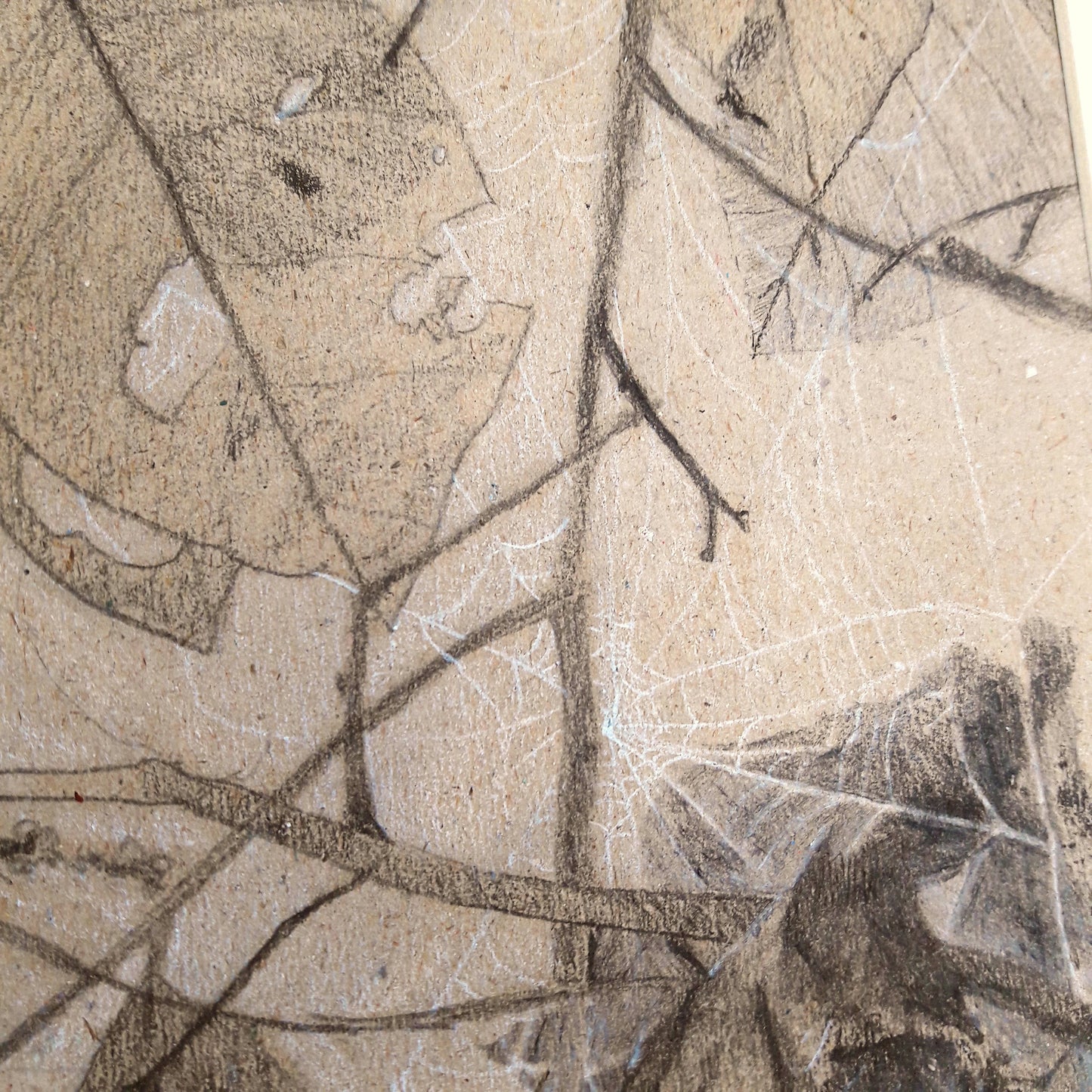 A close up photo of the white charcoal spiderweb in a drawing on brown paper.