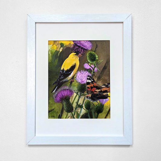 Framed wall art featuring a yellow bird perched among purple flowers, displayed in a white frame against a light gray wall.