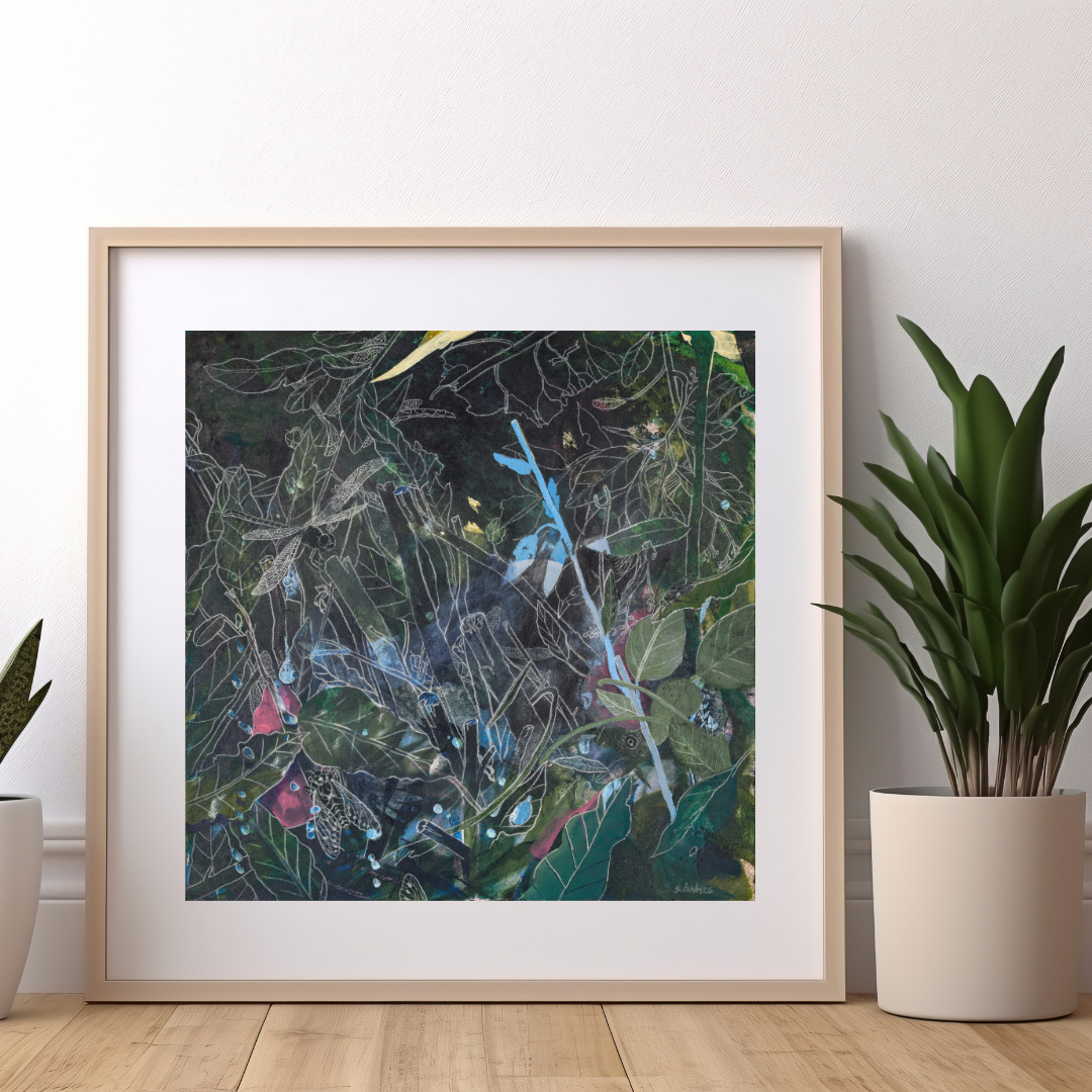 A photograph of a green and blue art print framed, leaning against a white wall. There is a potted plant on either side of the framed print.