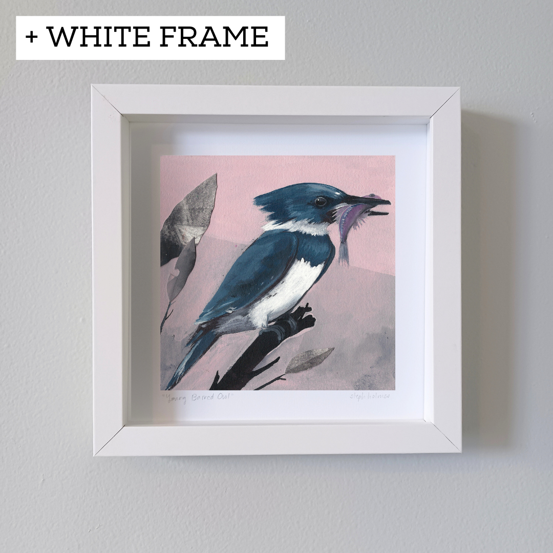 An art print featuring a blue Belted Kingfisher bird in white frame hanging on a white wall.