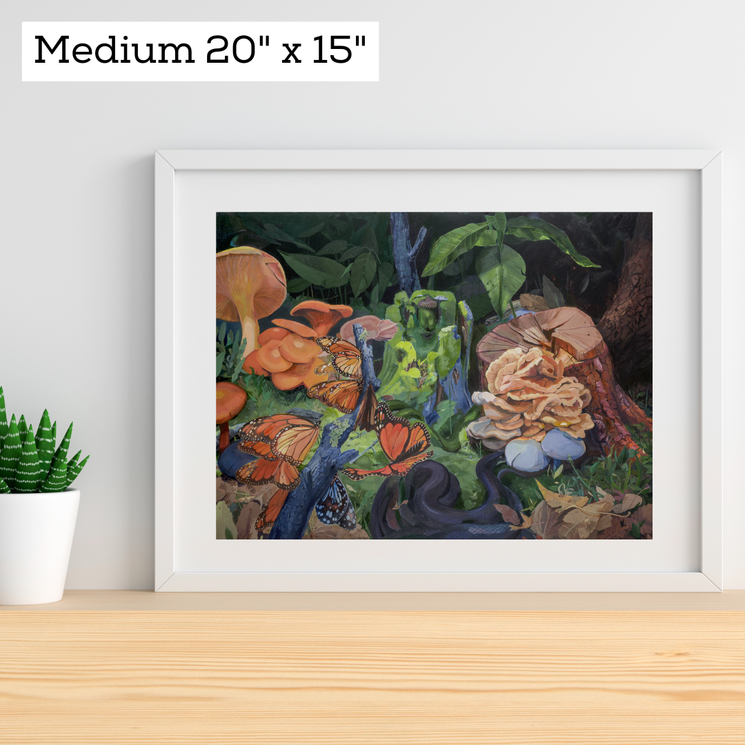 An art print featuring a forest floor scene in a white frame against a white wall.